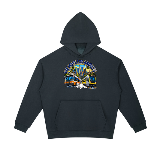We Move Los Angeles Pullover Hoodie — navy heavyweight brushed fleece with the LA transit badge printed on left chest and full back, featuring the LA skyline, Metro train, and bus.