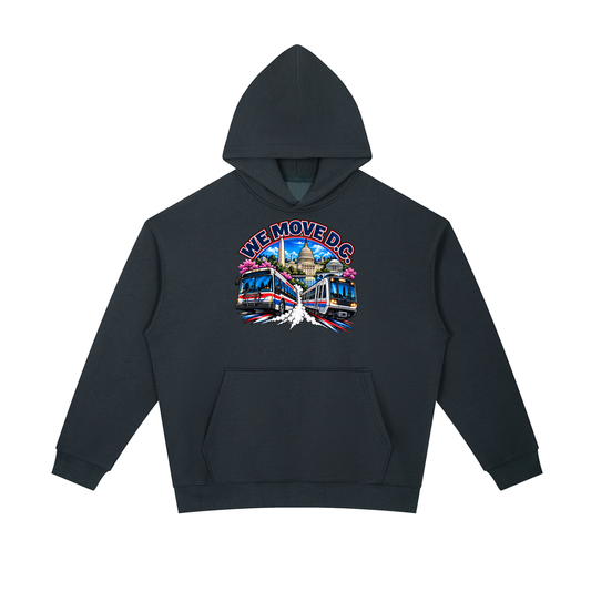 We Move DC Pullover Hoodie — navy heavyweight brushed fleece with the DC transit badge printed on left chest and full back, featuring the Washington skyline, Metro train, and bus.